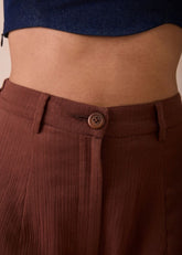 A Model Wearing Brown Organic Cotton Under The Sun Organic Cotton Trousers, curated by Only Ethikal